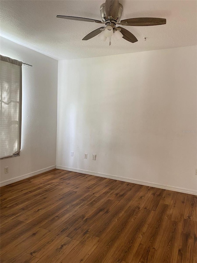 unfurnished room with ceiling fan, dark hardwood / wood-style flooring, and a textured ceiling