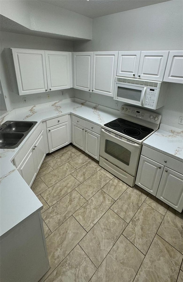 kitchen featuring white cabinets, white appliances, and sink