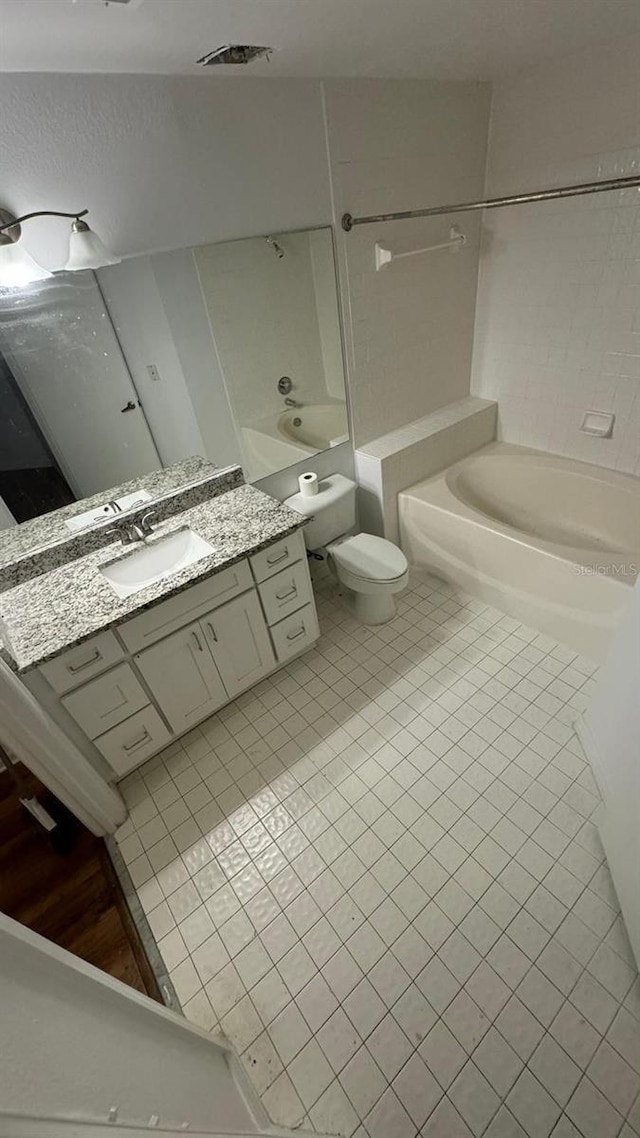 bathroom featuring toilet, vanity, and tile patterned floors