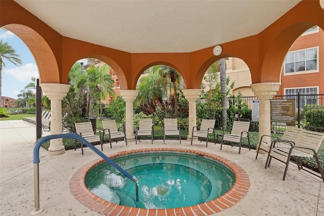 view of pool with a hot tub