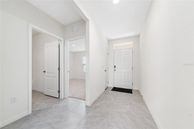 hallway featuring light tile patterned floors