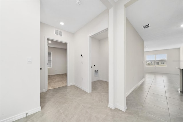 hallway with light tile patterned floors