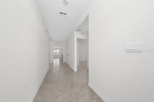 corridor with light tile patterned floors