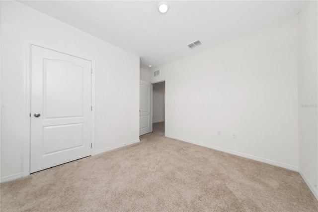 unfurnished room with light carpet