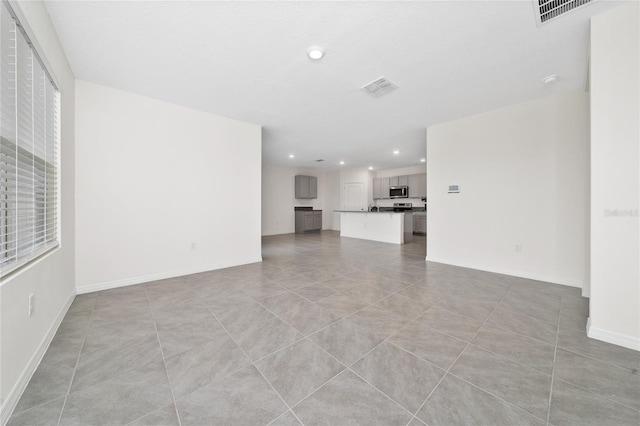 unfurnished living room featuring light tile patterned floors