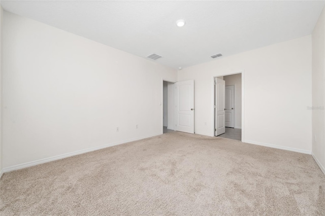 empty room featuring light colored carpet