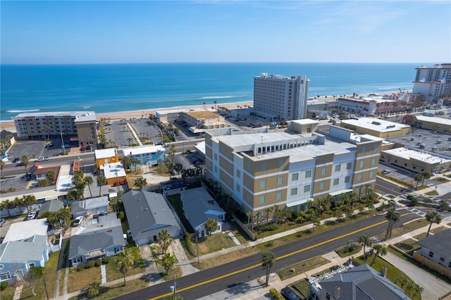 birds eye view of property with a view of the beach and a water view