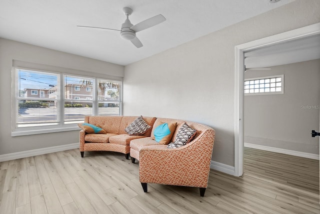 living room featuring light hardwood / wood-style floors and ceiling fan