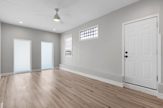 foyer with ceiling fan and light hardwood / wood-style floors