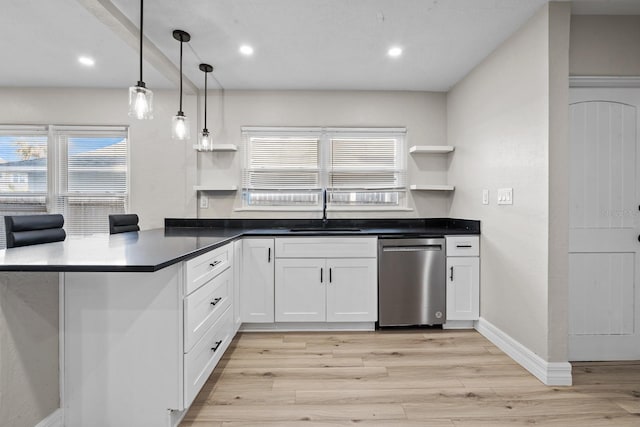 kitchen featuring sink, decorative light fixtures, dishwasher, kitchen peninsula, and white cabinets