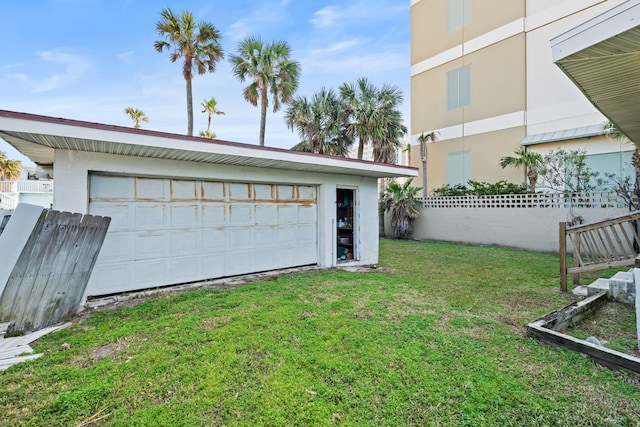 garage featuring a lawn