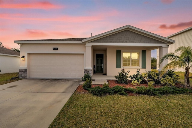 view of front of home with a lawn, a garage, and covered porch