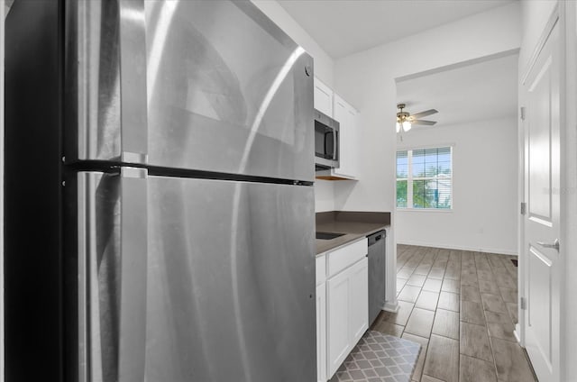 kitchen featuring ceiling fan, white cabinetry, and stainless steel appliances