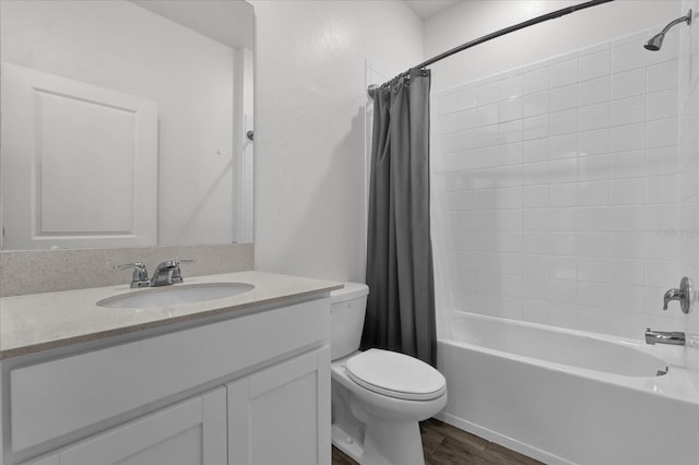 full bathroom with hardwood / wood-style flooring, vanity, toilet, and shower / tub combo