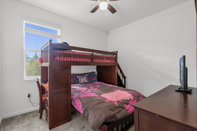 carpeted bedroom with ceiling fan and multiple windows