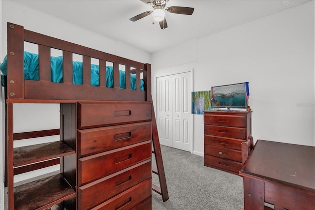 carpeted bedroom with a closet and ceiling fan