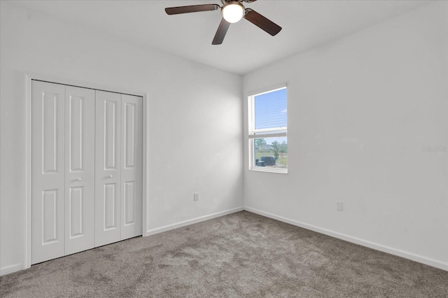 unfurnished bedroom with a closet, light colored carpet, and ceiling fan