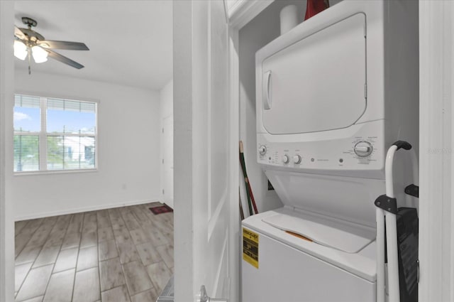 washroom with ceiling fan, stacked washer and dryer, and light wood-type flooring