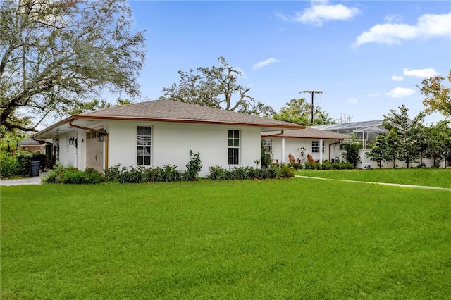 ranch-style house featuring a lanai and a front lawn