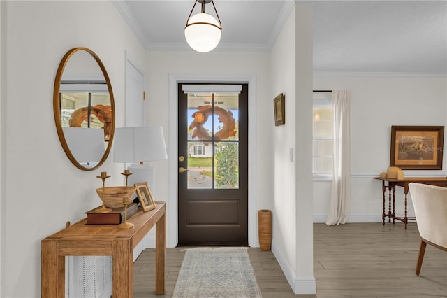 doorway to outside featuring crown molding and light hardwood / wood-style flooring