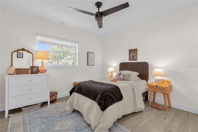 bedroom with light hardwood / wood-style flooring and ceiling fan