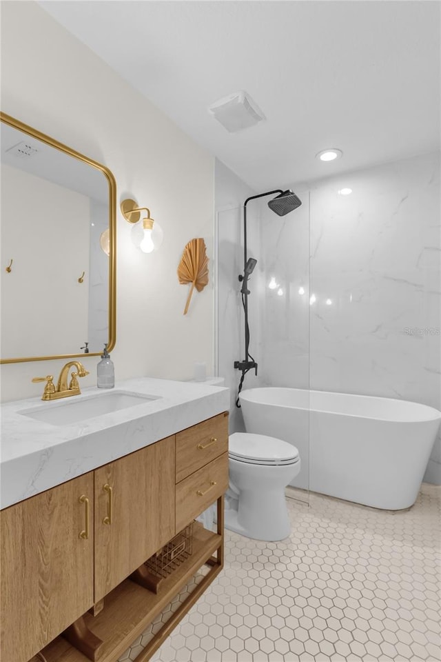 bathroom featuring tile patterned flooring, vanity, and toilet