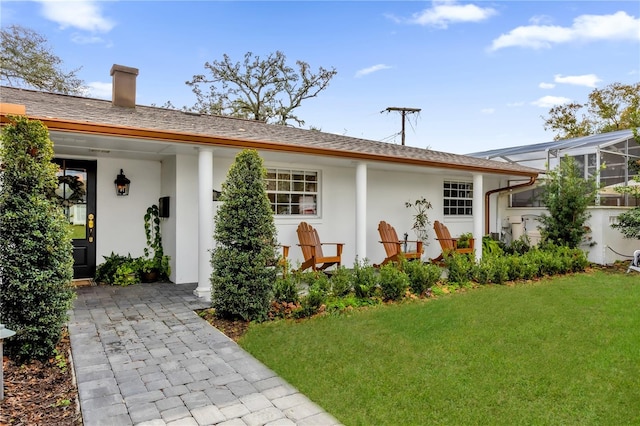 rear view of house with a yard