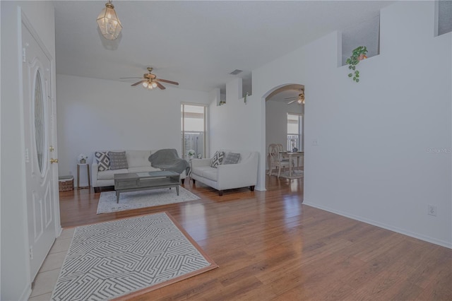 living room with ceiling fan and light wood-type flooring