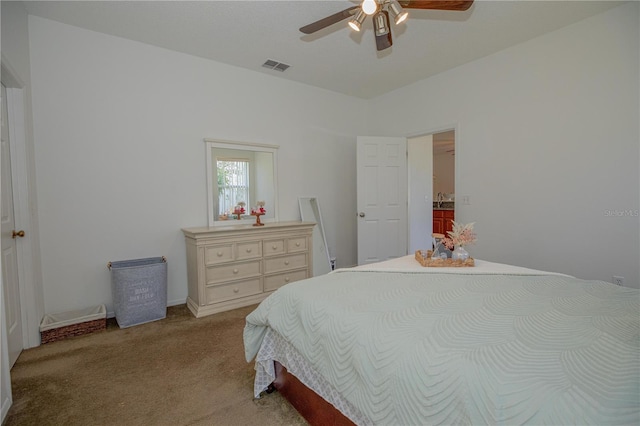 bedroom featuring ceiling fan, light colored carpet, and sink