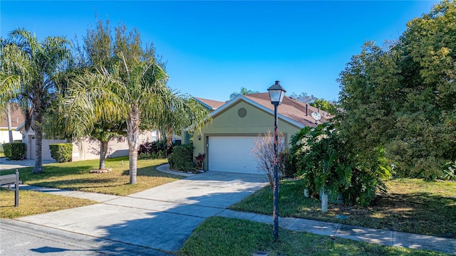 view of front of home with a front yard and a garage