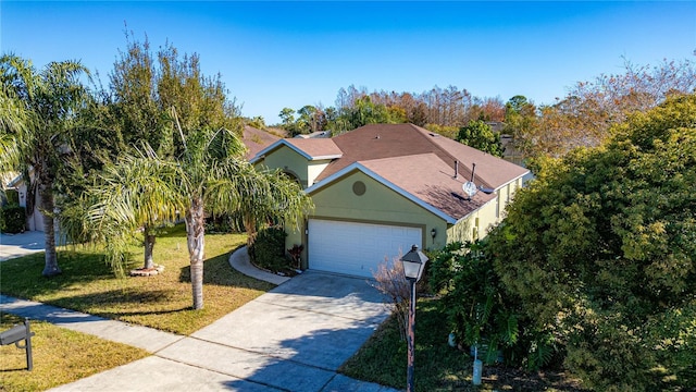 view of front of home featuring a garage and a front lawn