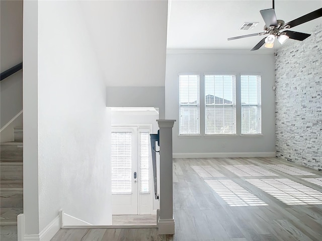 interior space with ceiling fan, ornamental molding, and light hardwood / wood-style flooring