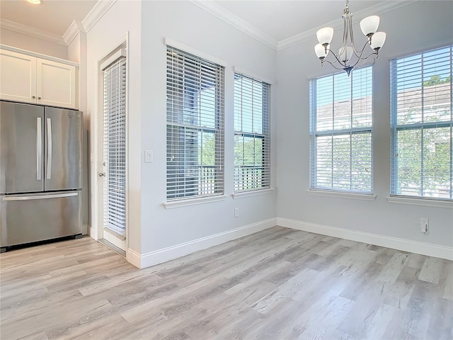 unfurnished dining area with a chandelier, light hardwood / wood-style floors, and plenty of natural light