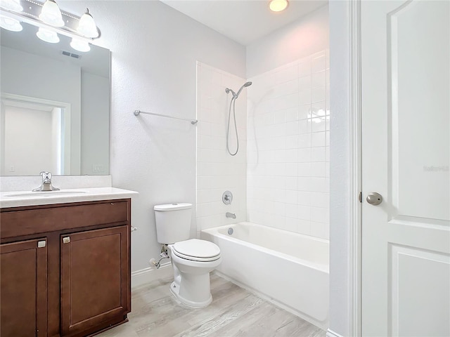 full bathroom featuring vanity, wood-type flooring, bathtub / shower combination, and toilet