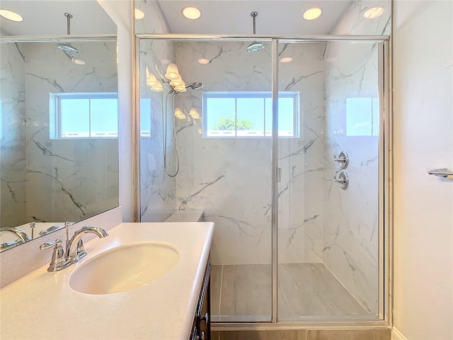 bathroom with ornamental molding, vanity, a healthy amount of sunlight, and walk in shower