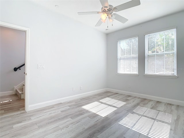 spare room featuring light hardwood / wood-style flooring and ceiling fan