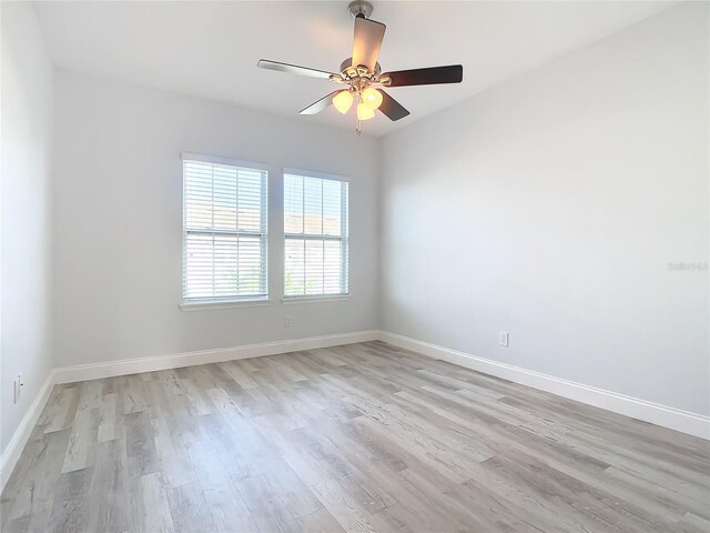 spare room with ceiling fan and light hardwood / wood-style flooring