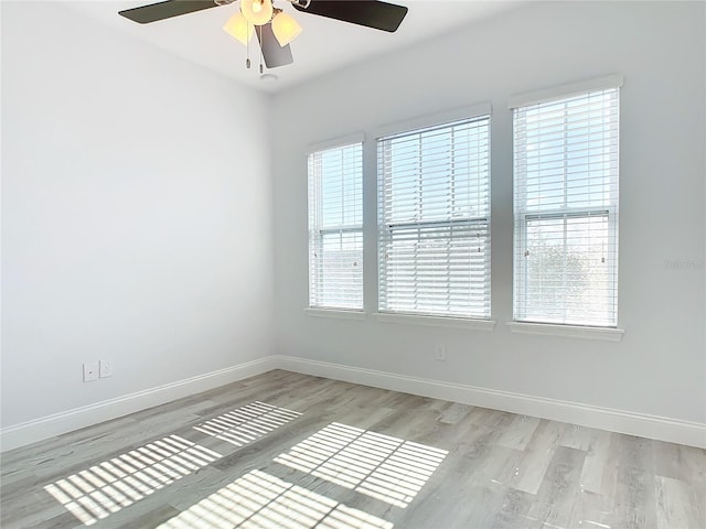 empty room with light wood-type flooring and ceiling fan