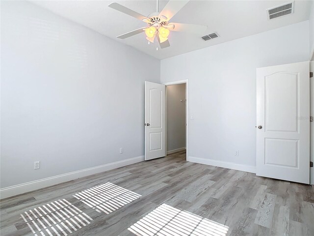 empty room featuring ceiling fan and light hardwood / wood-style floors