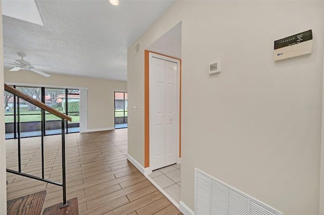 corridor with a textured ceiling