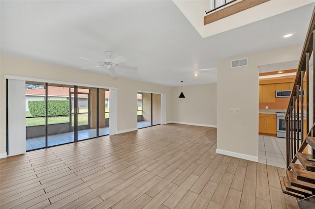 unfurnished living room featuring ceiling fan