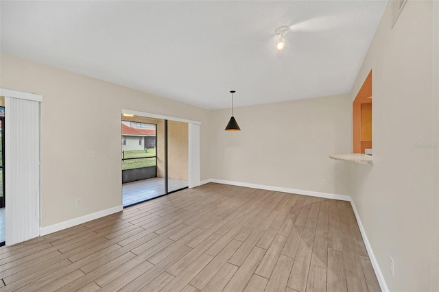 unfurnished room with light wood-type flooring