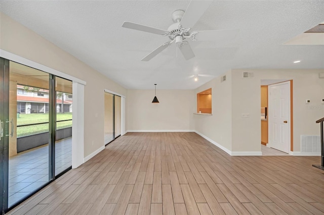 spare room with a textured ceiling and ceiling fan