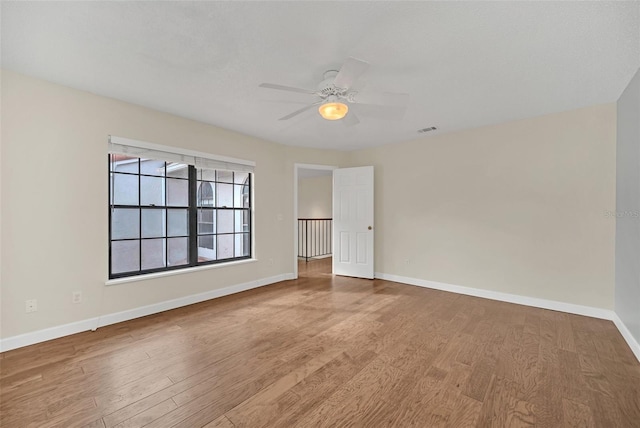 unfurnished room with ceiling fan and wood-type flooring