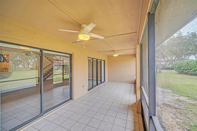 unfurnished sunroom with lofted ceiling and ceiling fan