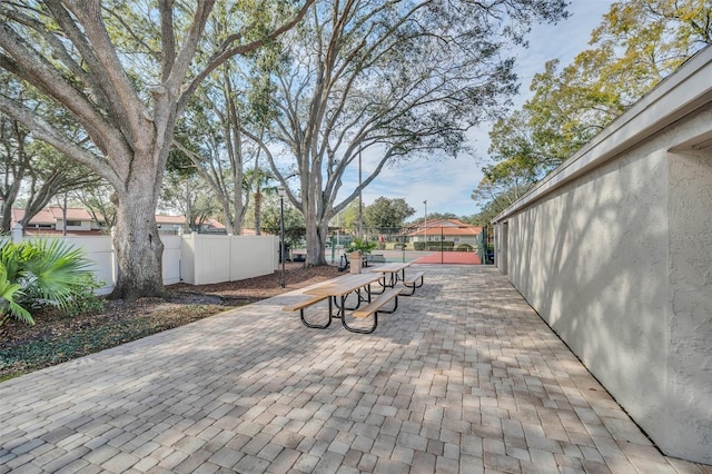 view of patio / terrace featuring tennis court