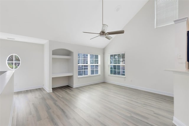 unfurnished living room with ceiling fan, light hardwood / wood-style floors, and high vaulted ceiling