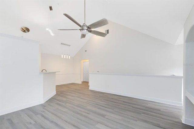 interior space featuring ceiling fan, high vaulted ceiling, and light wood-type flooring