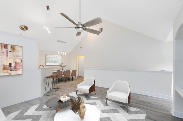 living area with ceiling fan, high vaulted ceiling, and hardwood / wood-style flooring