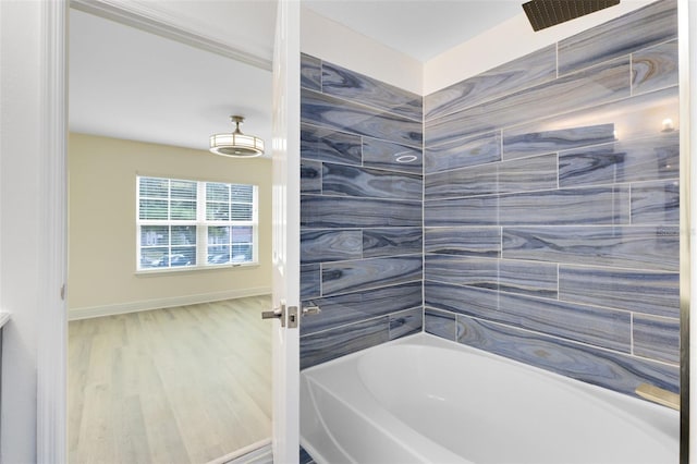 bathroom with hardwood / wood-style floors and shower / tub combination